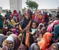 Somalis forced to flee their homes wait for food distribution in Mogadishu, Somalia