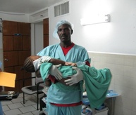 A clinician carries a young patient in Cange.